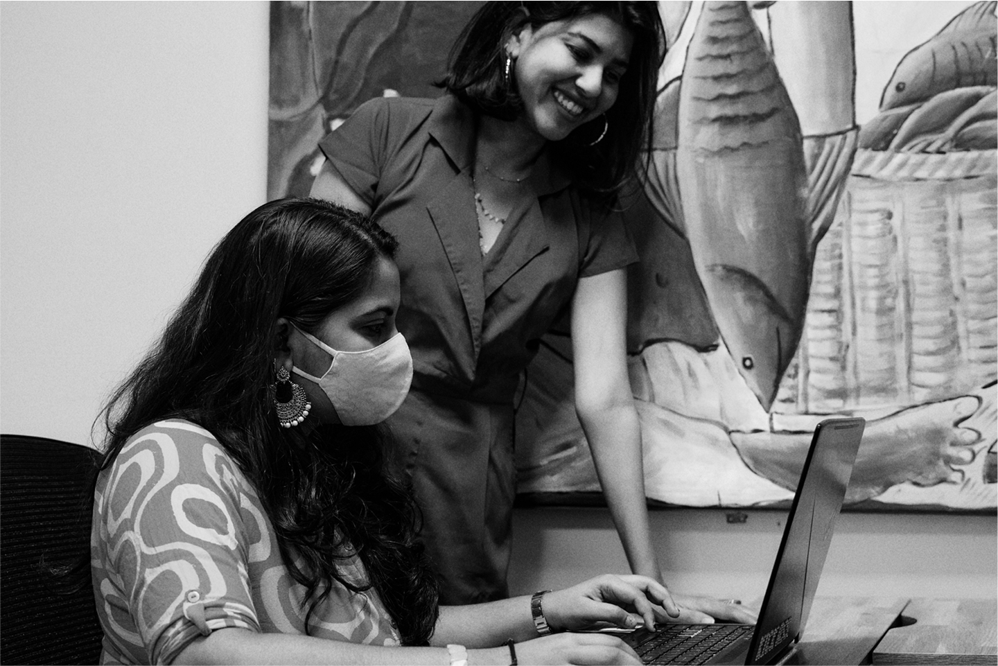 Two people working together at a laptop